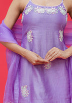 Purple dress with floral embroidery on a red background