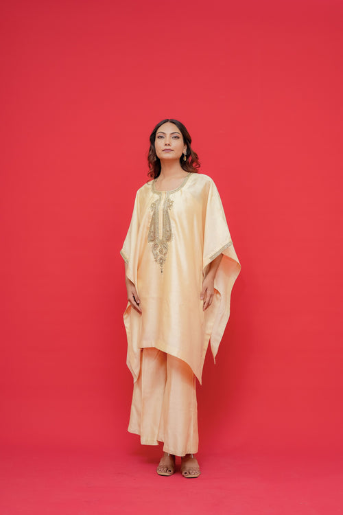 Woman wearing a Kaftan with Fabric chiniya silk Hand Embroidery against a red background