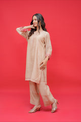 Beige embroidered straight kurta with matching palazzo pants featuring pink lace cuff detailing for women.