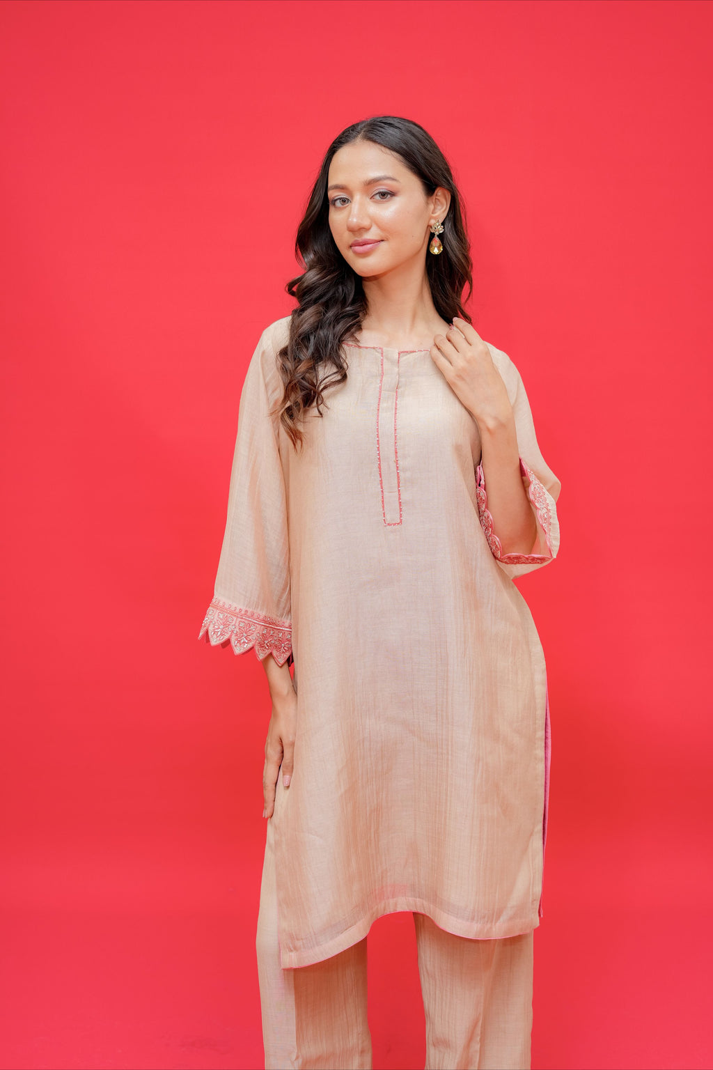 Beige embroidered straight kurta with matching palazzo pants featuring pink lace cuff detailing for women.