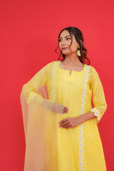 Woman wearing a yellow outfit with a red background