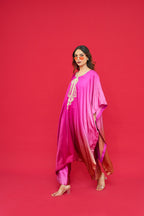 Woman wearing a Nyasa Silk Ombre Kaftan Set with a red background