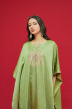 Woman wearing a Olive Green Linen Satin Kaftan Set  against a red background
