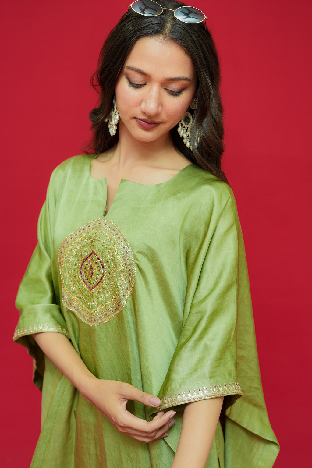 Woman wearing a Olive Green Linen Satin Kaftan Set with a red background