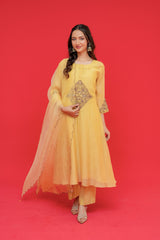 Woman wearing a yellow traditional outfit with a red background