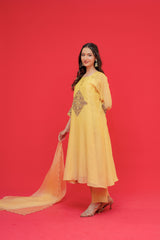 Woman in a yellow traditional outfit with a red background