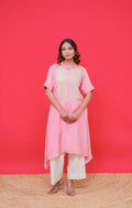 Woman wearing a pink traditional outfit against a red background