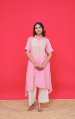 Woman wearing a pink traditional outfit against a red background