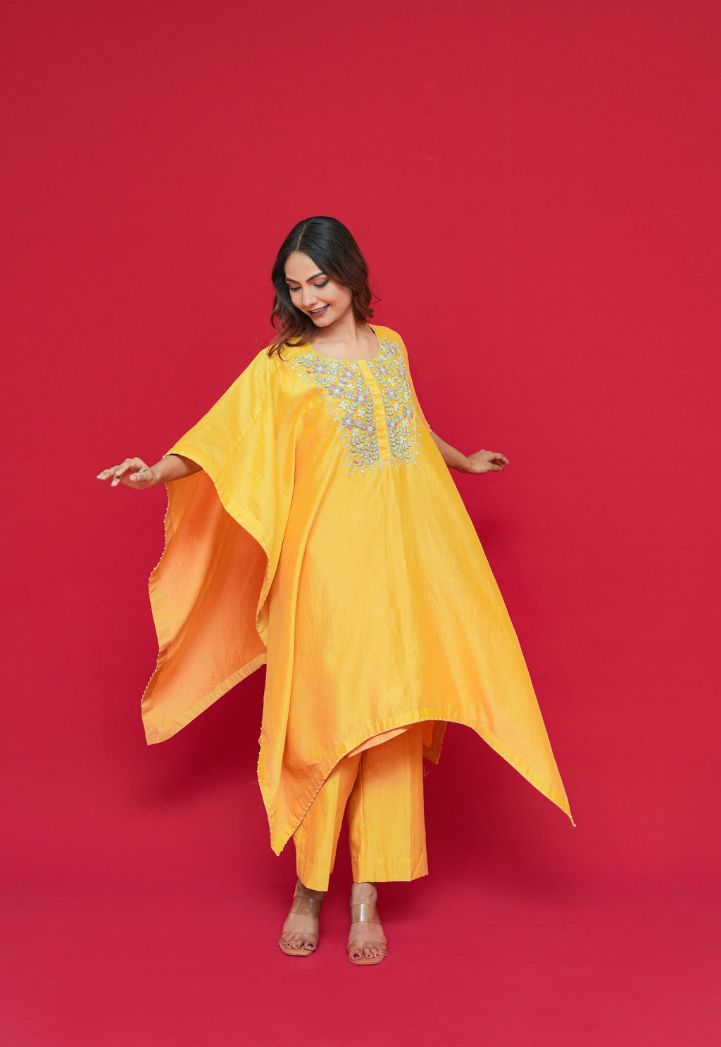 Woman wearing a yellow Yellow Chanderi Silk Kaftan Set with a red background