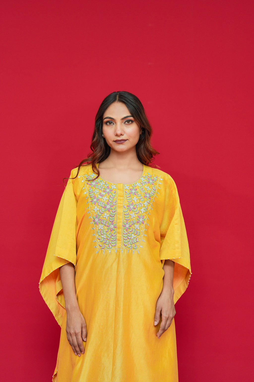 Woman wearing a Yellow Chanderi Silk Kaftan Set  against a red background